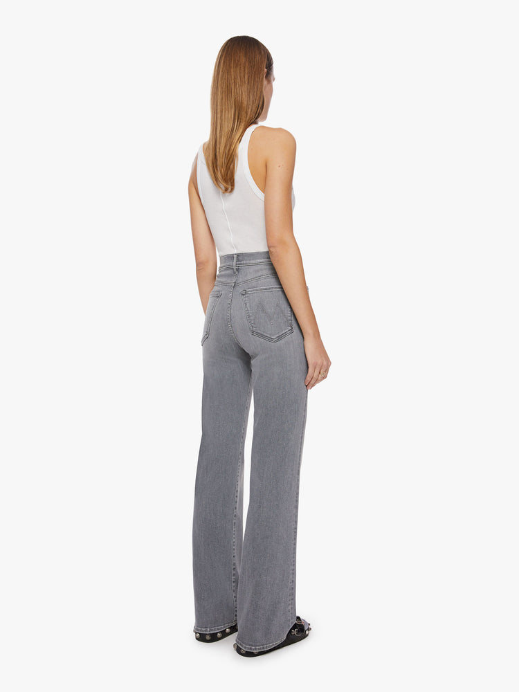 Back view of a woman super high-waisted jeans with a loose fit, wide leg and 34-inch inseam with a clean hem in a grey hue.