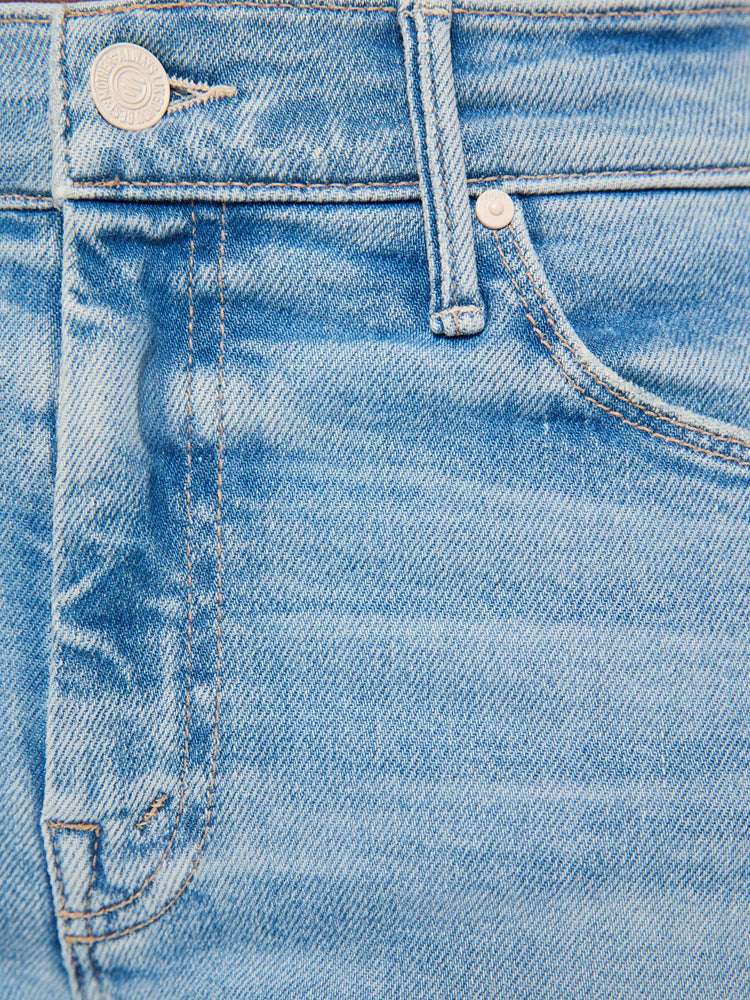 Swatch view of a woman in a light blue mid-rise flare has a zip fly, 31-inch inseam and a frayed hem.