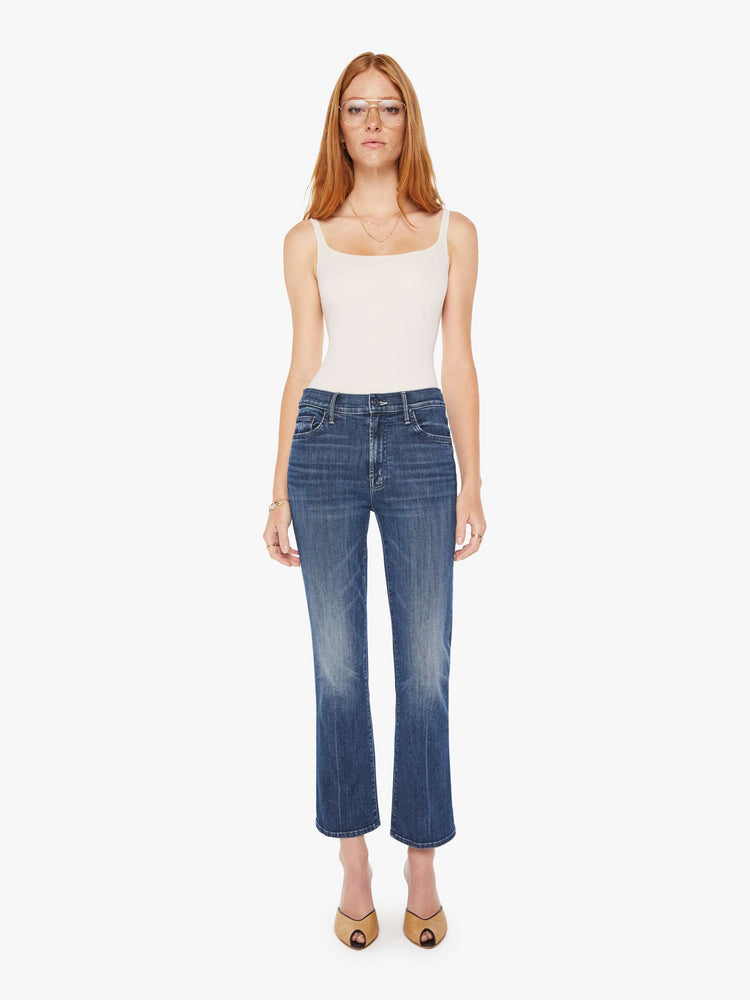 Front view of a womens dark denim wash jean featuring a mid rise and a ankle length flare.