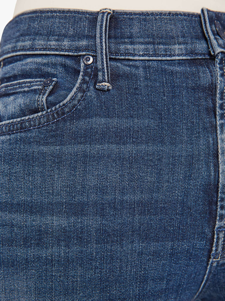 close up swatch of a dark blue denim jean.
