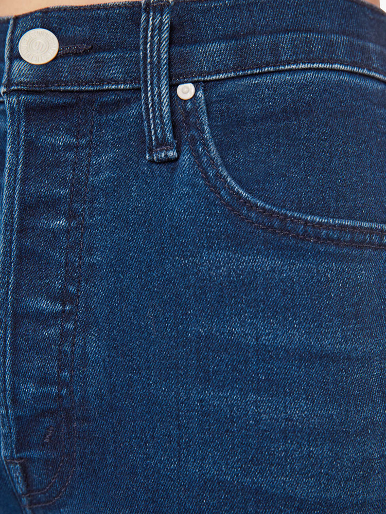 Swatch view of a woman high-rise flare with a button fly and a clean ankle-length hem in a dark blue wash.