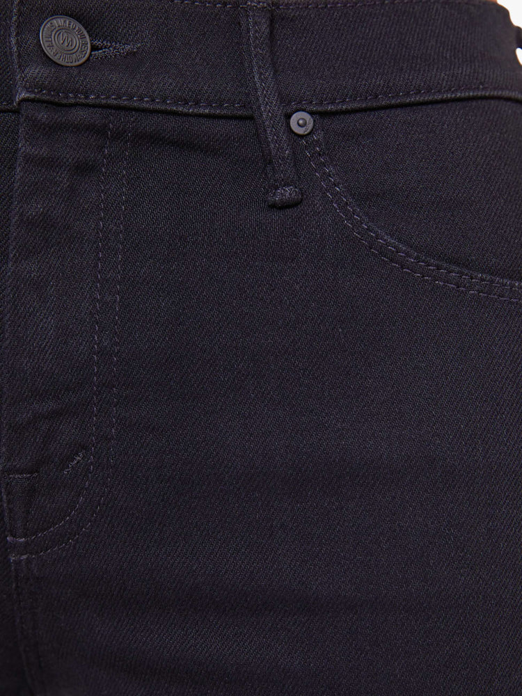 Swatch view of a woman in a dark black flare jean with a mid rise and 31-inch inseam and a clean hem.