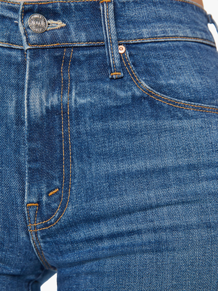 Swatch view of a mid rise blue flare jean with a 32 1/2-inch length inseam and a clean hem.