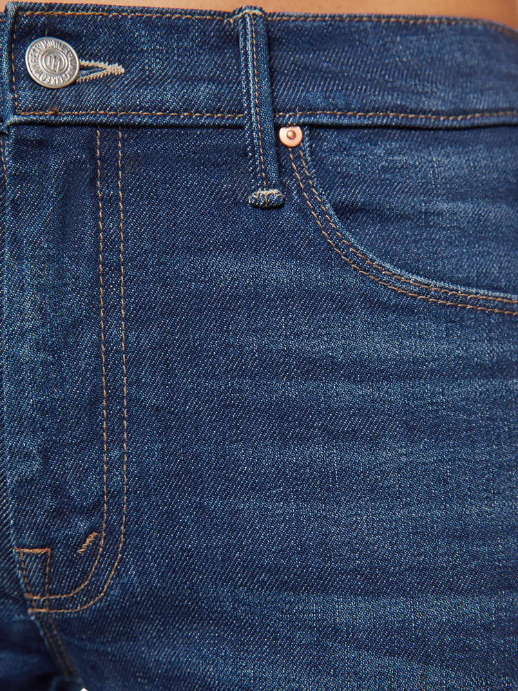 Swatch view of a dark blue mid rise jean with a 31-inch inseam and a clean hem.