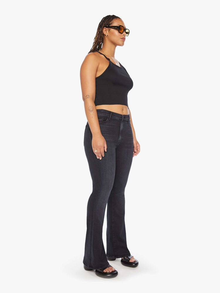 Front view of a woman flare jean has a mid rise with a 32 1/2-inch length inseam and a clean hem in a dark blue wash.