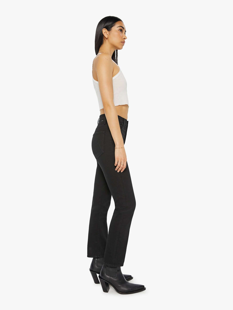 Side view of a women's black straight leg jean with a high rise and ankle length inseam