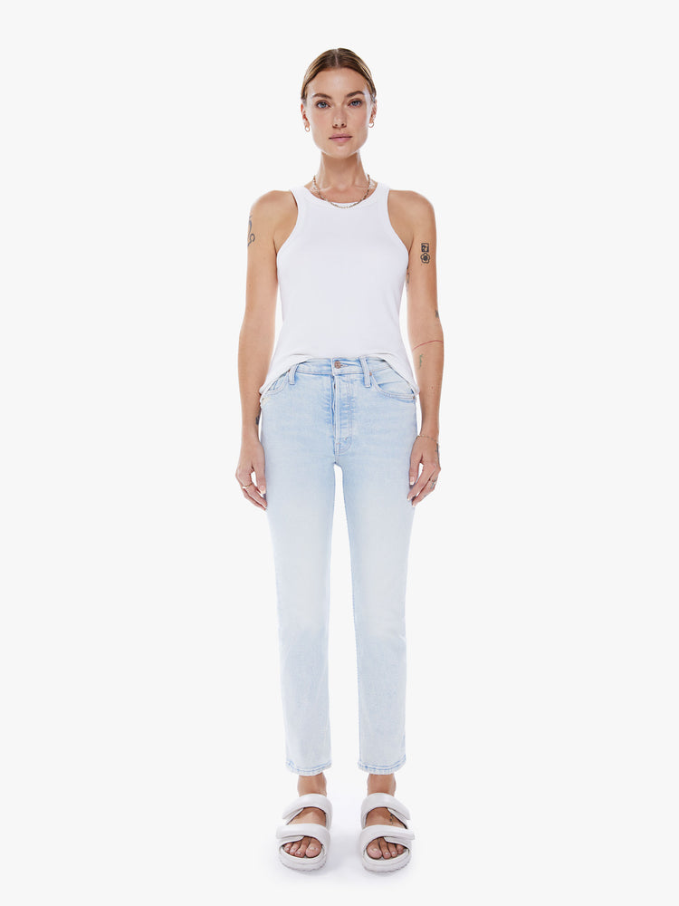 Front view of a women high-rise jean with a straight leg, button fly, ankle-length inseam and a clean hem in a light blue hue.
