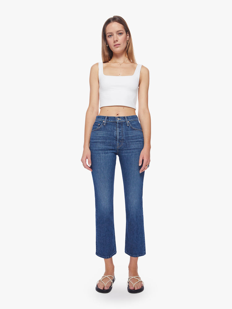 Front view of a women's high-rise jean with a straight leg, button fly, ankle-length inseam and a clean hem in a dark blue wash.