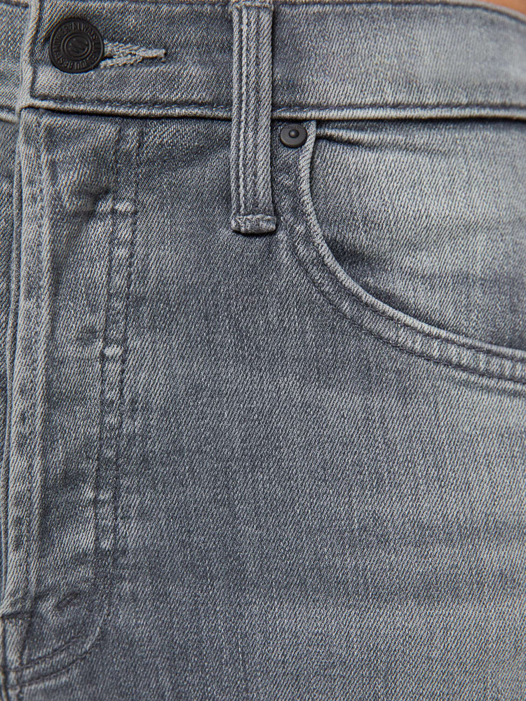 Swatch view of a woman in a faded grey wash high-rise straight leg with a button fly and an ankle-length inseam. 