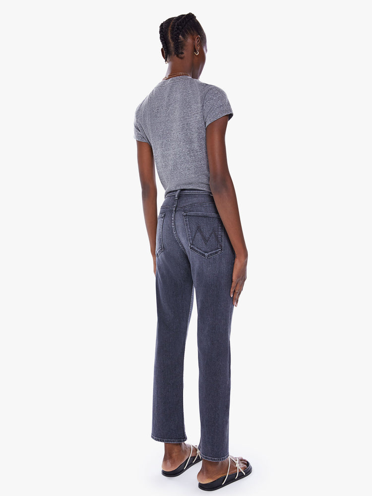 Back view of a woman high-rise jeans with a straight leg, button fly, ankle-length inseam and a clean hem.
