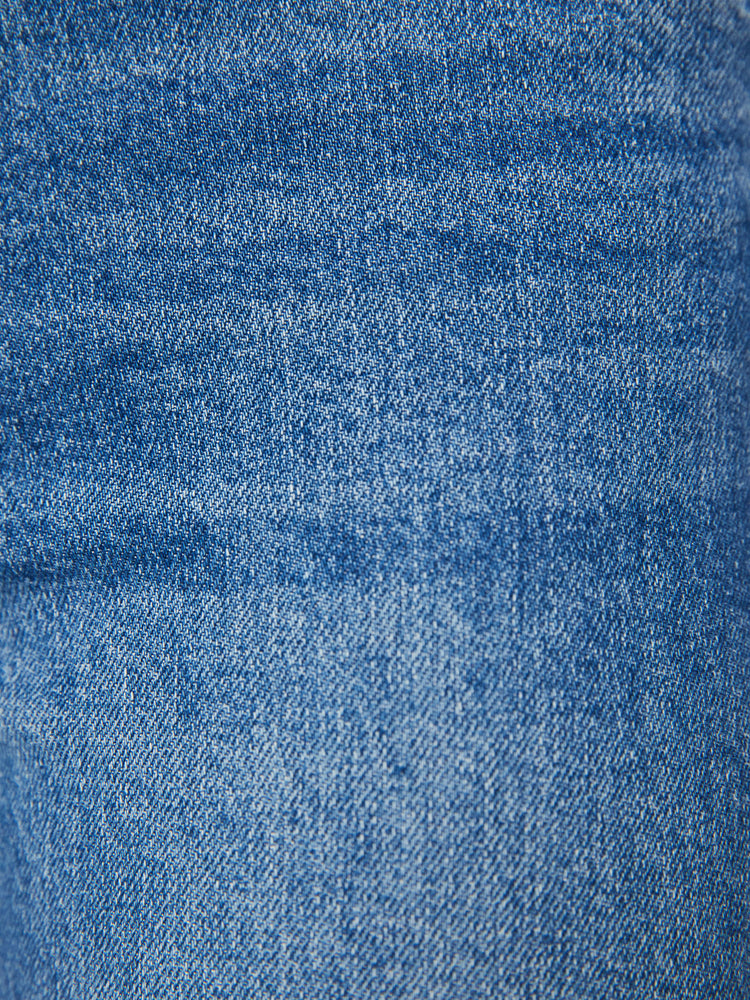 Swatch view of a woman high-rise jeans with a straight leg, button fly, ankle-length inseam and a frayed hem in a mid blue wash.