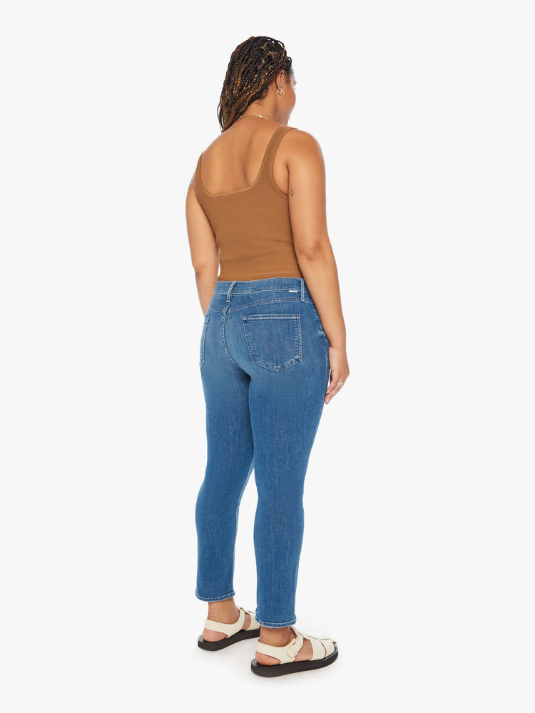 Back view of a womens medium blue wash jean featuring a mid rise, straight leg, and clean hem.