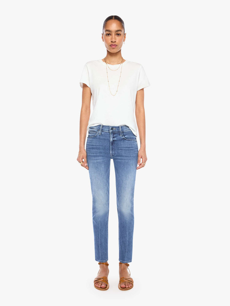 Front view of a womens classic medium blue wash denim jean featuring a mid rise, a slim straight leg, an ankle length clean hem, and subtle whiskering details.