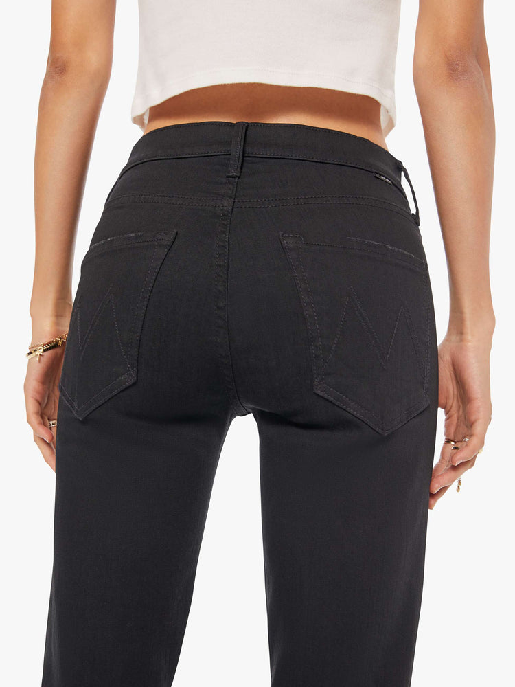 Back waist view of a woman a black mid-rise straight leg with an ankle-length inseam and a clean hem.