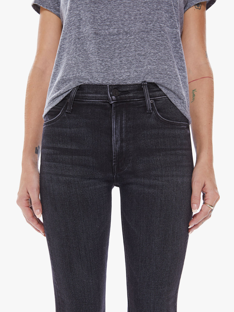Front close up view of women's black straight leg jean with mid-rise and ankle length inseam.