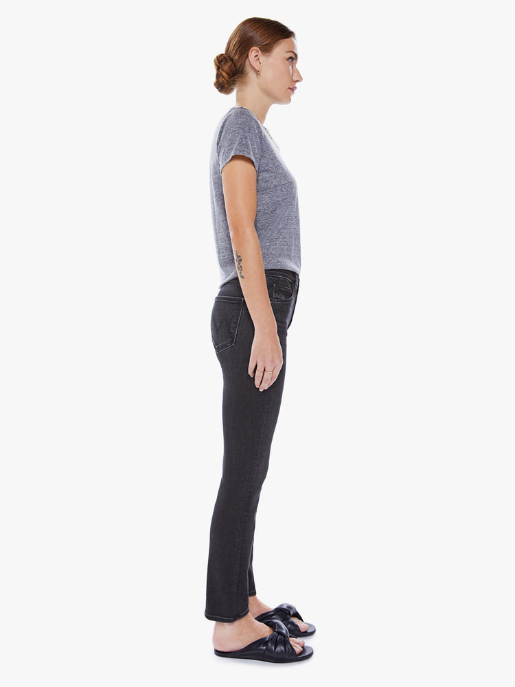Side view of women's black straight leg jean with mid-rise and ankle length inseam.