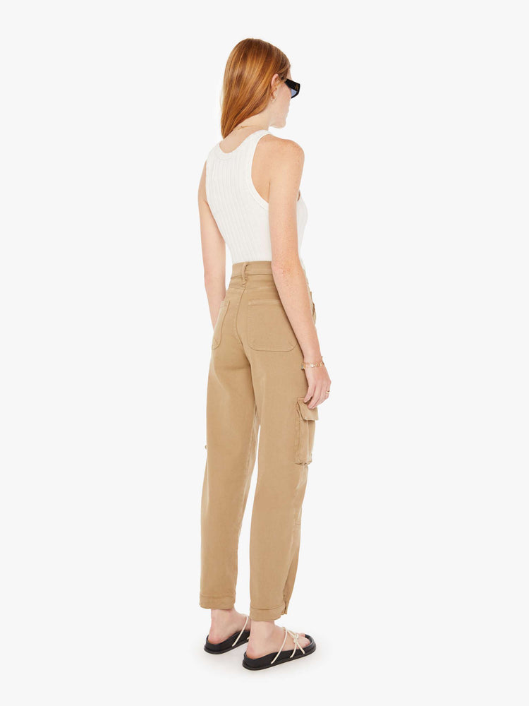 Back view of a womens brown cargo pants featuring a high rise and flood length hem.