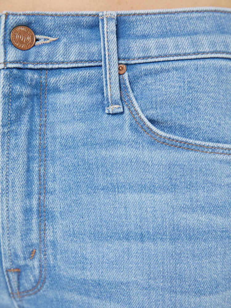 Swatch view of a woman in a light blue mid-rise jean has a straight leg, zip fly, cropped inseam and a frayed hem.