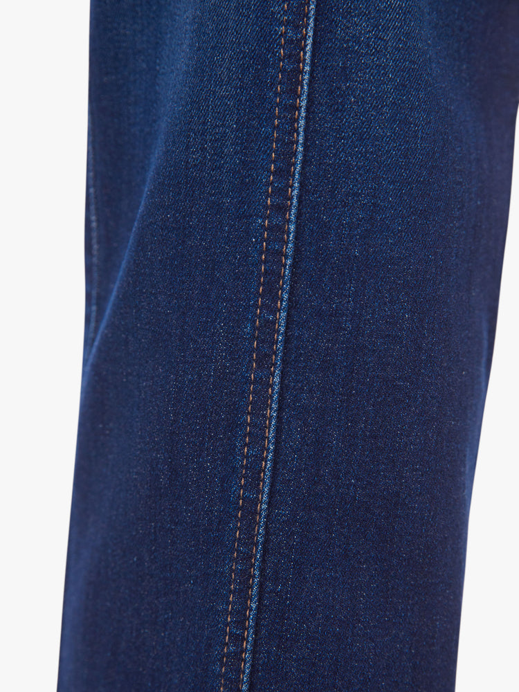 Swatch view of a woman dark blue wash high-waisted ankle-length pants with a wide straight leg, cargo pockets and seams down the front.