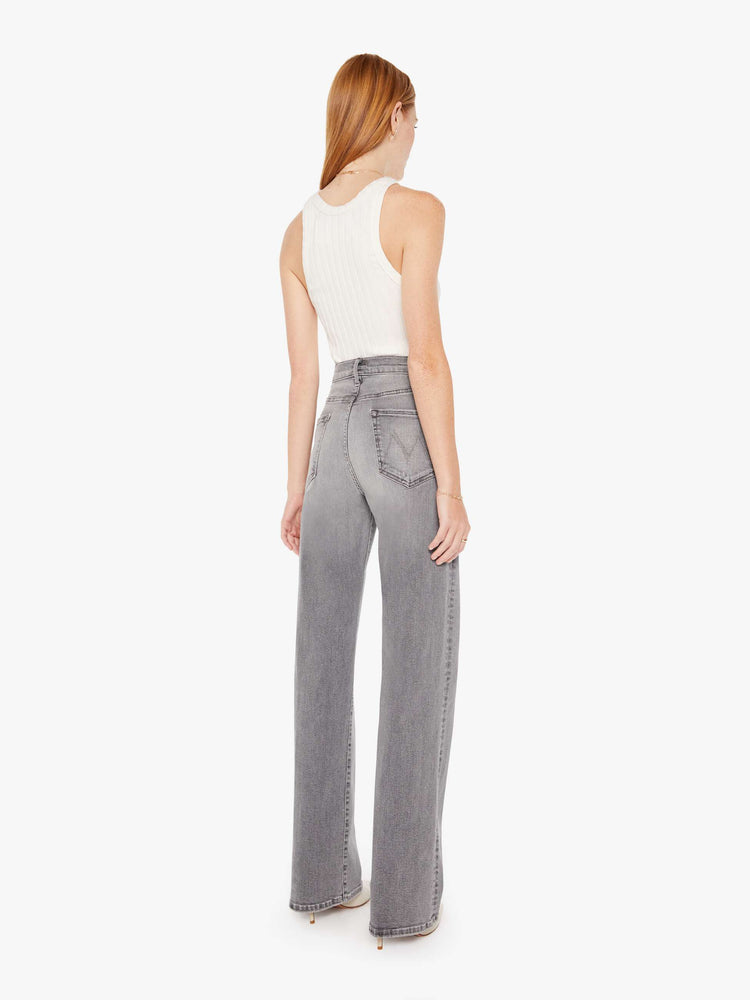 Back view of a grey wash jean featuring a super high rise, a wide leg, and full length clean hem.