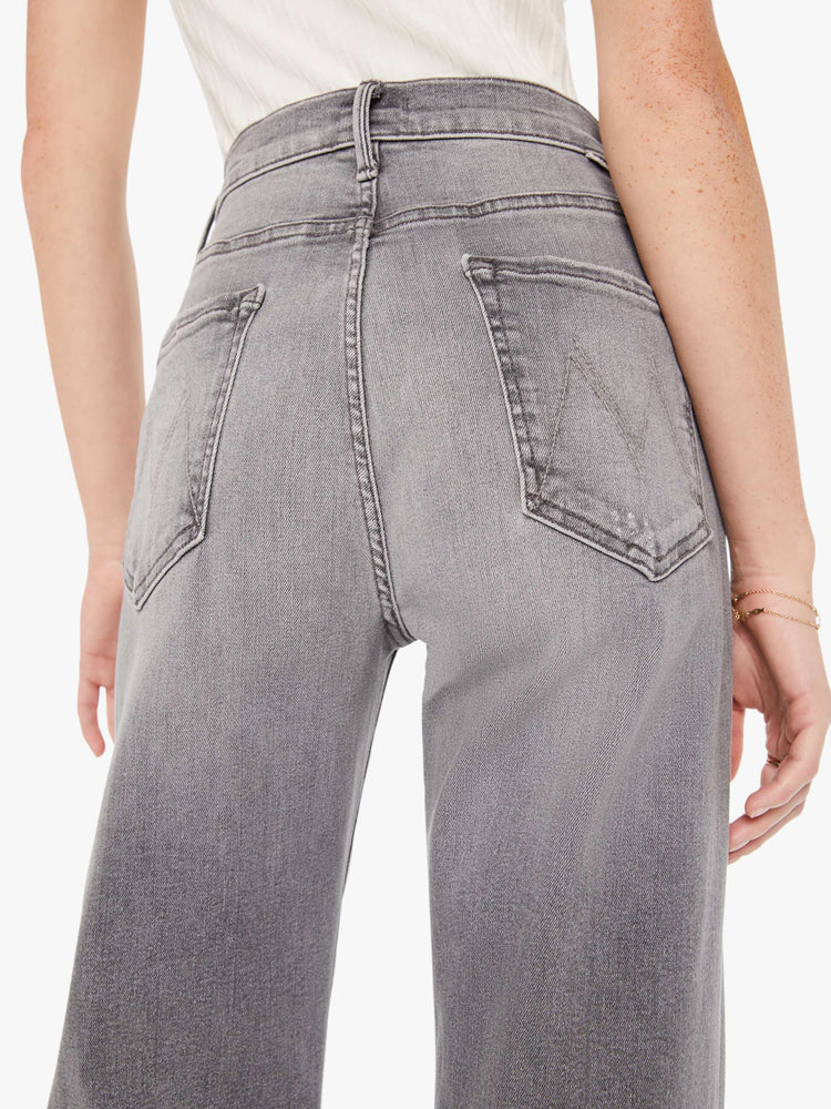 Back close up view of a grey wash jean featuring a super high rise and a wide leg.