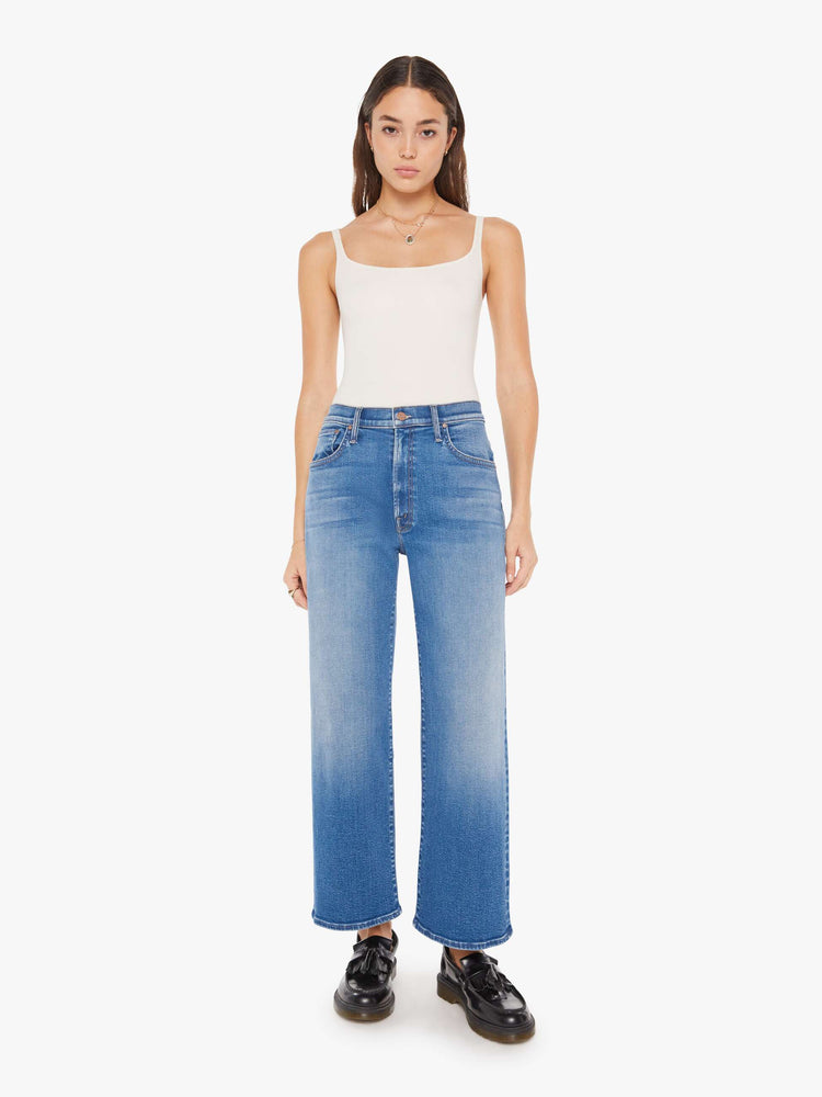 Front view of a woman igh-waisted jeans with a loose wide leg and an ankle-length inseam in a medium blue wash.