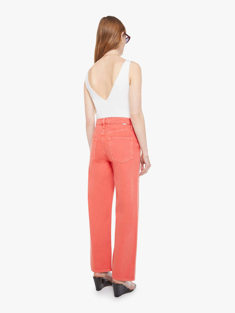 Back view of a woman in pants that sit lower on the hips with a zip fly, loose wide leg and a clean ankle-length inseam.