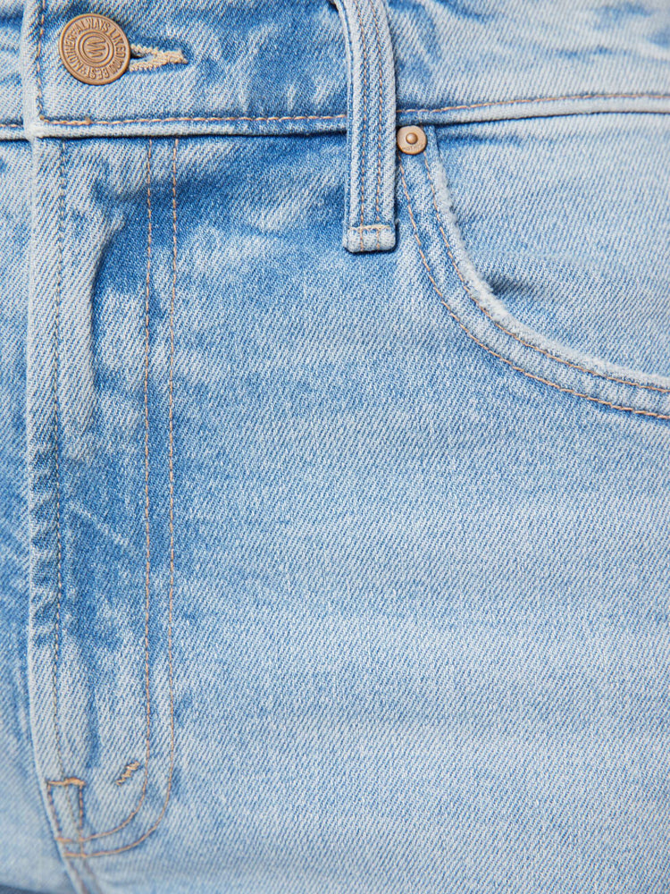 Swatch view of a woman in a light blue jeans designed to sit lower on the hips with a zip fly, loose straight leg and a clean ankle-length inseam.