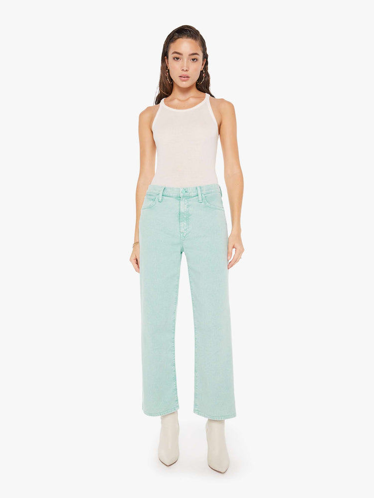 Front view of a woman wearing a light teal acid wash pant featuring a wide leg and ankle length hem.