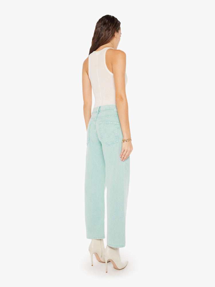 Back view of a woman wearing a light teal acid wash pant featuring a wide leg and ankle length hem.