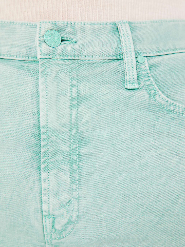 Close up swatch detail view of a teal acid wash pant.