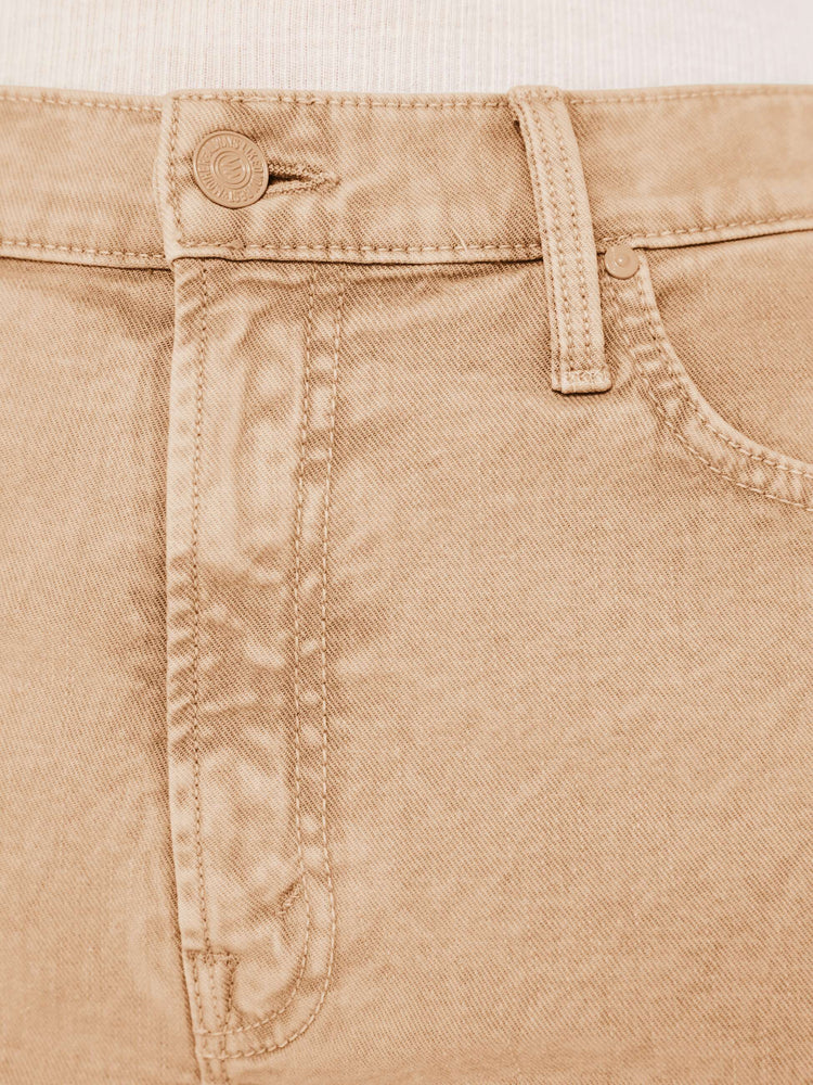 Close up swatch detail view of a light brown acid wash pant.