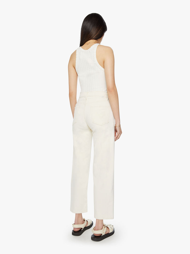 Back view of a woman high waisted jeans with a loose wide leg and an ankle-length inseam in a creamy white wash.