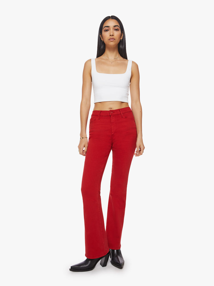 Front view of a bright red hue flare has a high rise, long 31-inch inseam and clean hem.
