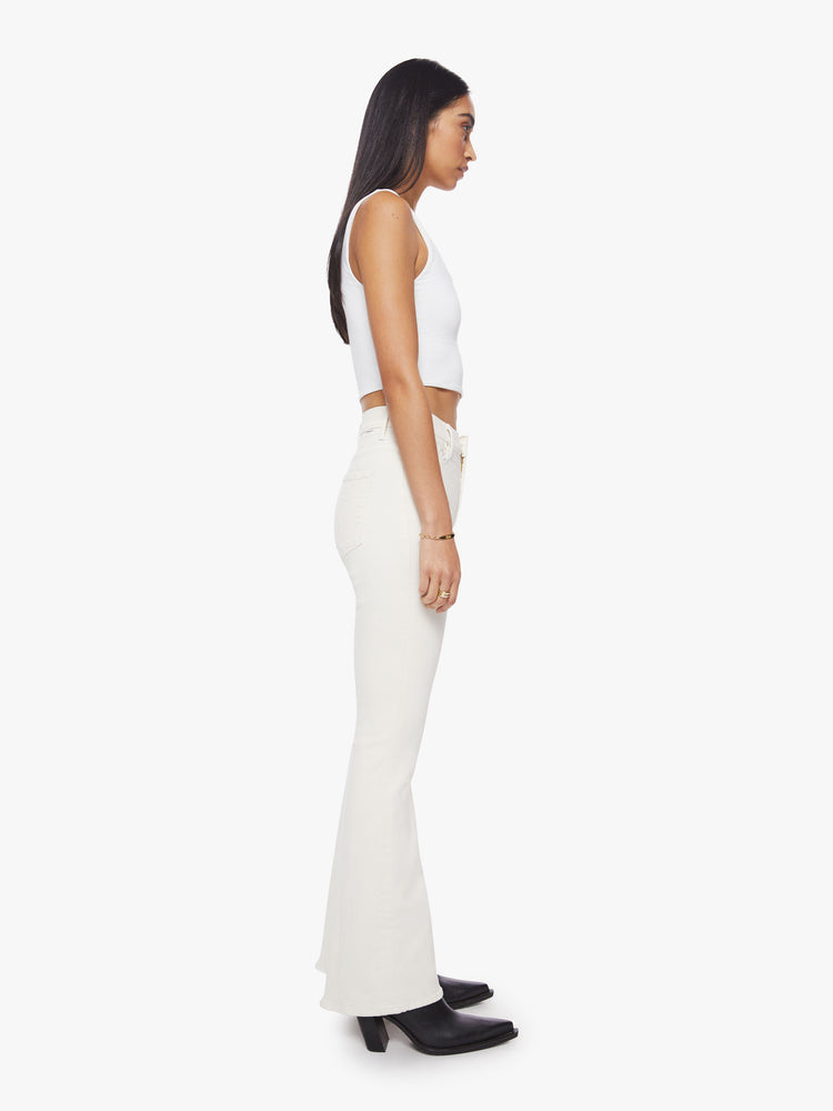 Side view of off white hue high rise flare with long 31-inch inseam and clean hem.
