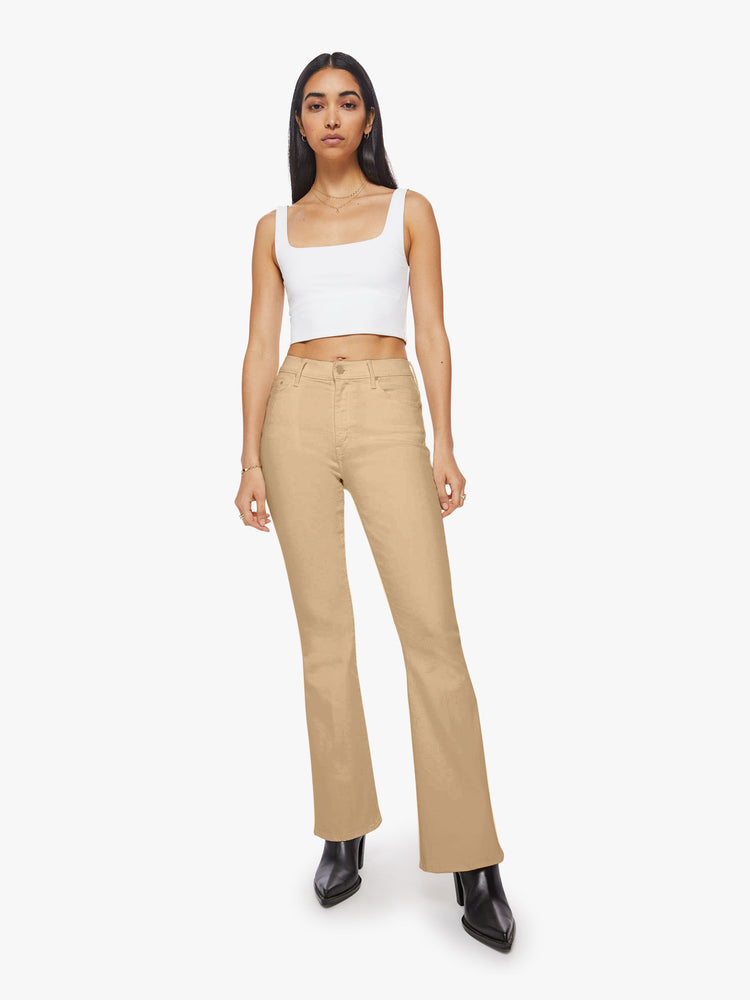 Front view of woman sandy hue flare with long 31-inch inseam and clean hem.