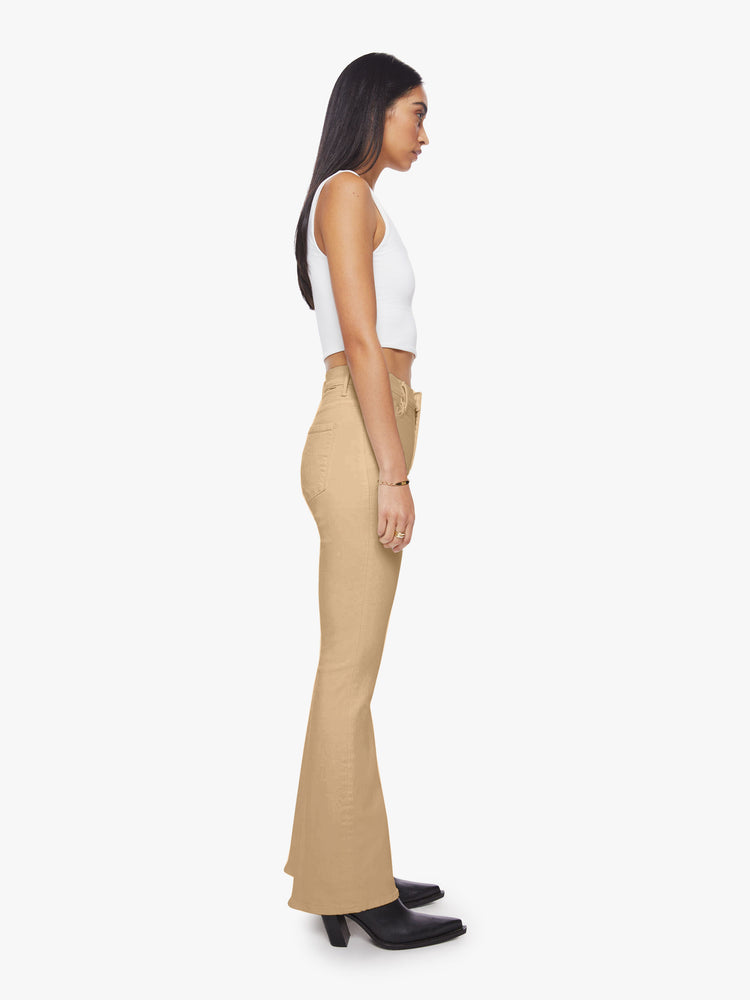 Side view of woman sandy hue flare with long 31-inch inseam and clean hem.