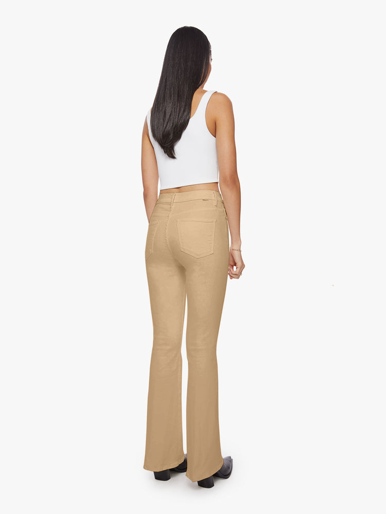 Back view of woman sandy hue flare with long 31-inch inseam and clean hem.