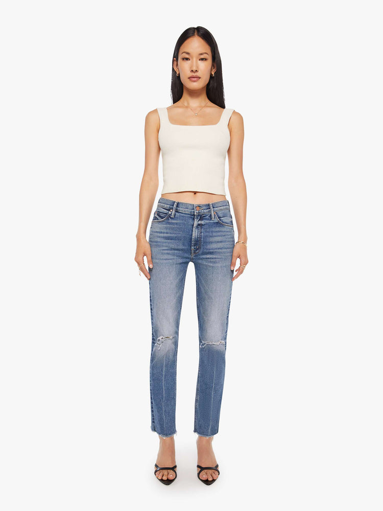 Front  view of a women's medium blue mid-rise jean with a slim straight fit and a frayed ankle length hem.