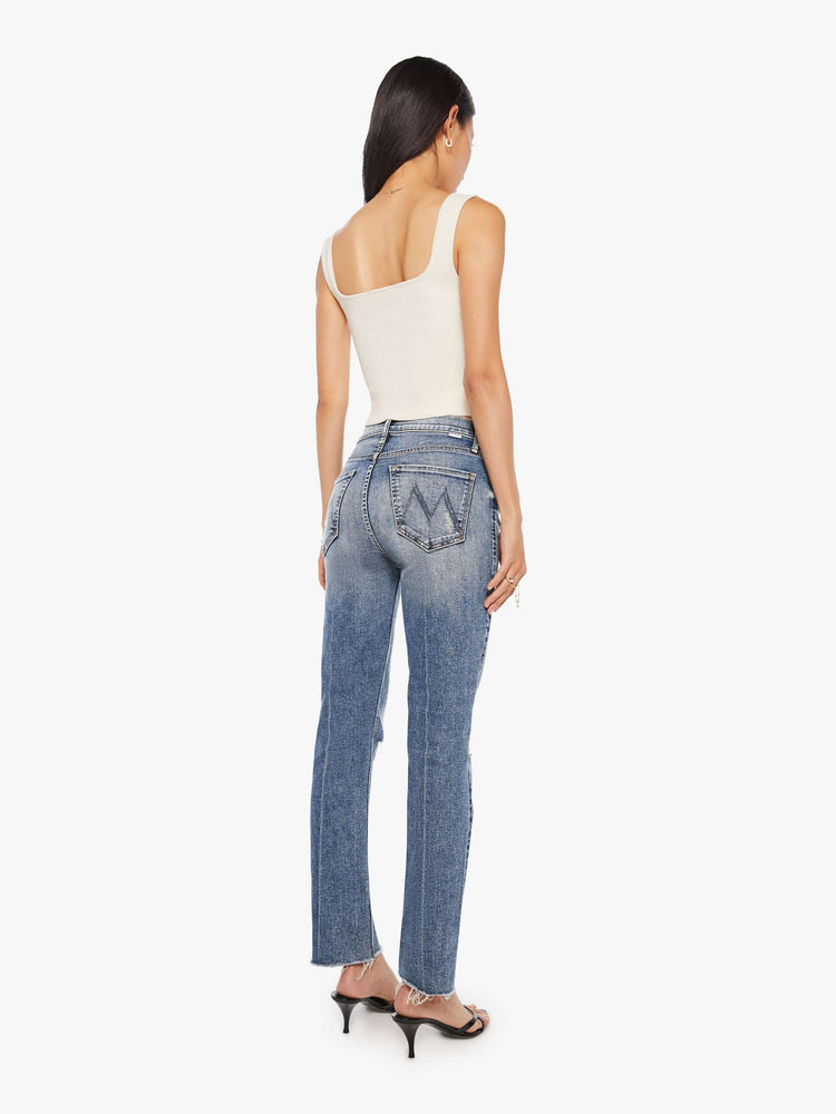 Back   view of a women's medium blue mid-rise jean with a slim straight fit and a frayed ankle length hem.