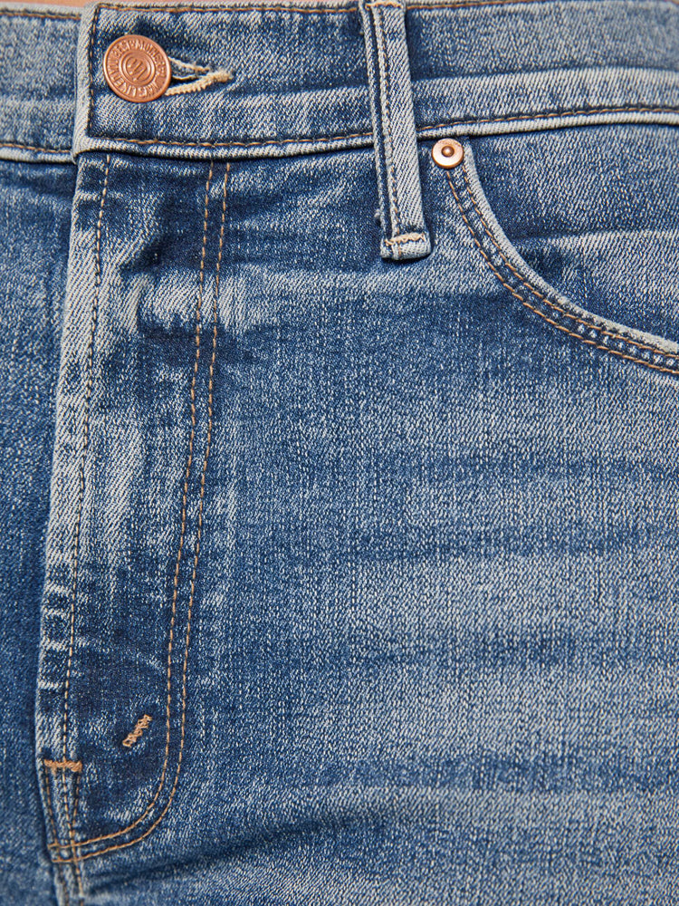 Swatch  view of a women's medium blue mid-rise jean with a slim straight fit and a frayed ankle length hem.