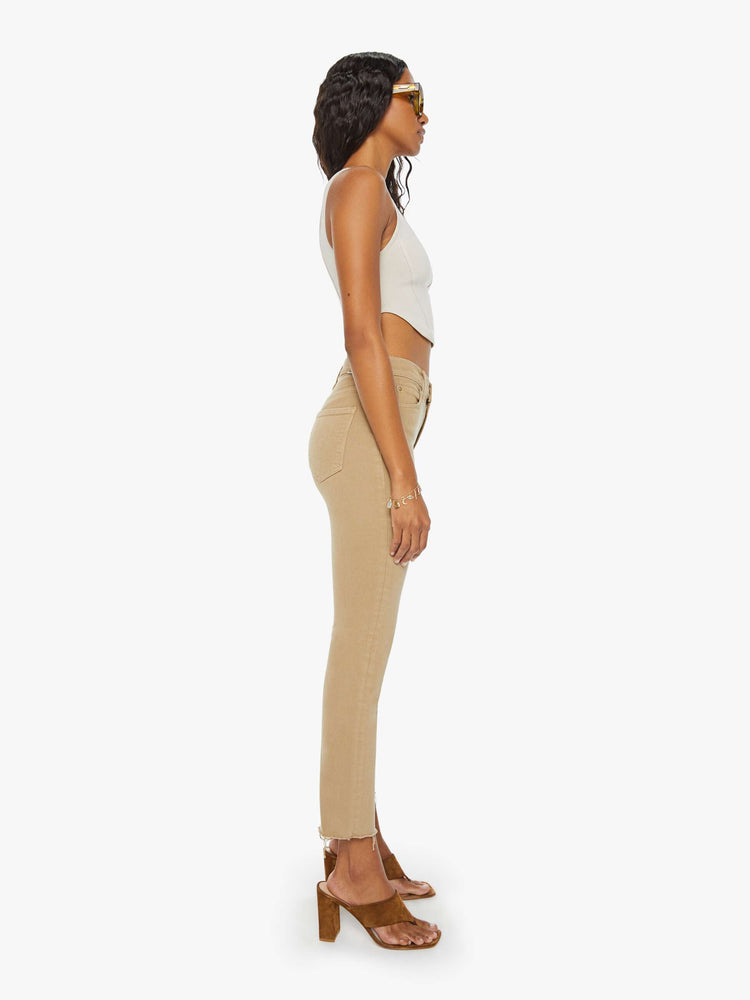 Side view of a womens brown pant featuring a mid rise and a straight leg with a frayed hem.
