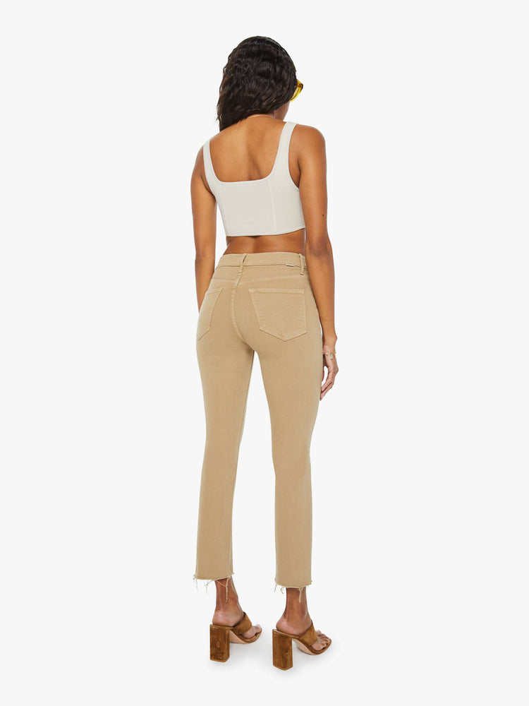 Back view of a womens brown pant featuring a mid rise and a straight leg with a frayed hem.