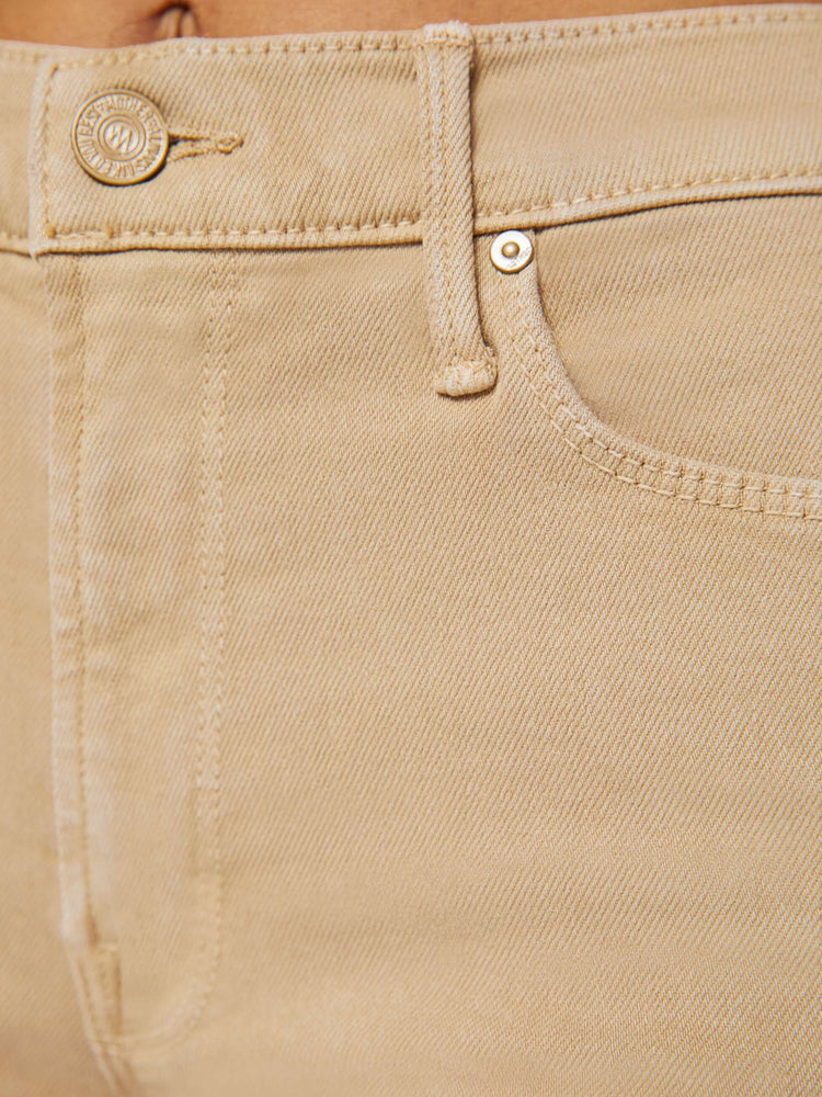 Swatch close up view of a light brown wash jean.