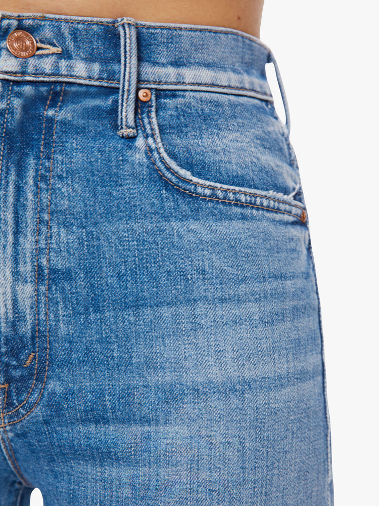 Swatch view of a woman super high-waisted straight-leg jeans with a V-shaped back hem and a shorter hem in the front in a light blue wash.