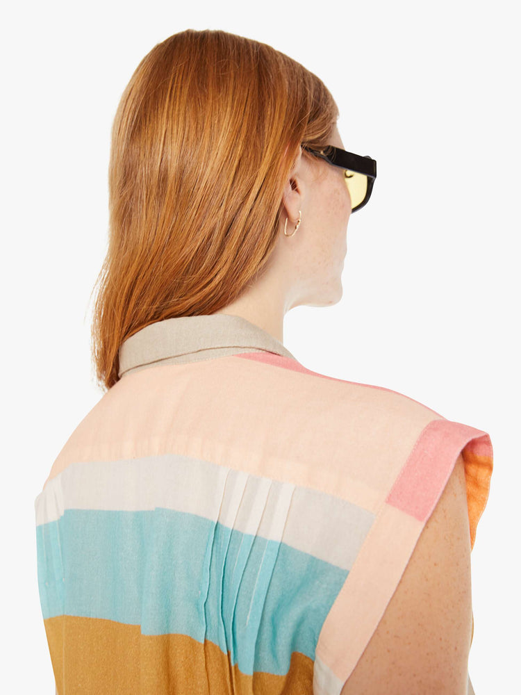Back close up view of a womens sleeveless button down featuring a notched collar and a wide stripe pattern.