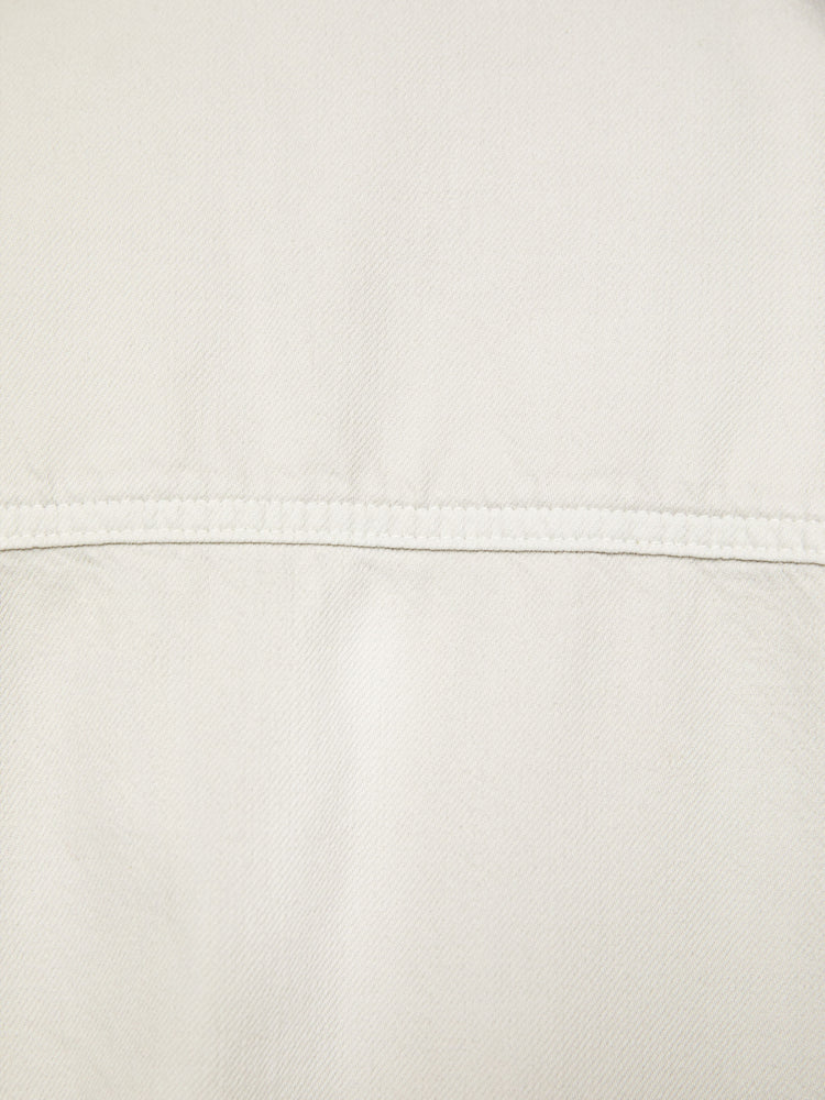 Swatch view of a woman oversized button-up with drop shoulders, patch pockets and a curved hem in an off white hue.