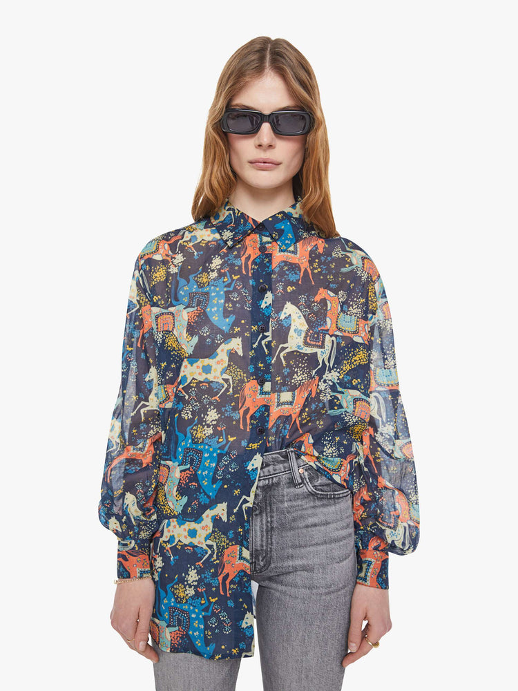 Front view of a woman in a horse print button-up blouse with long balloon sleeves and an extra-long hem.