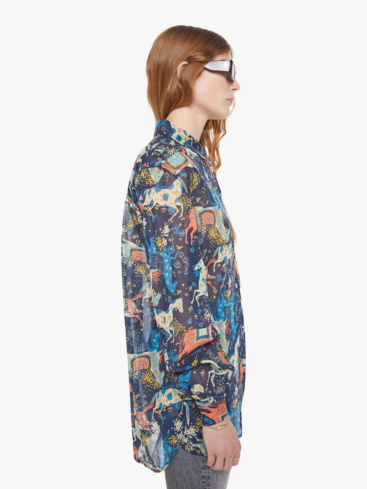 Side view of a woman in a horse print button-up blouse with long balloon sleeves and an extra-long hem.