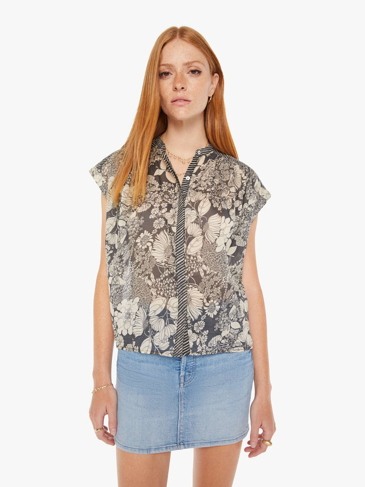 Front view of a black and white floral print button down blouse with a boxy fit.